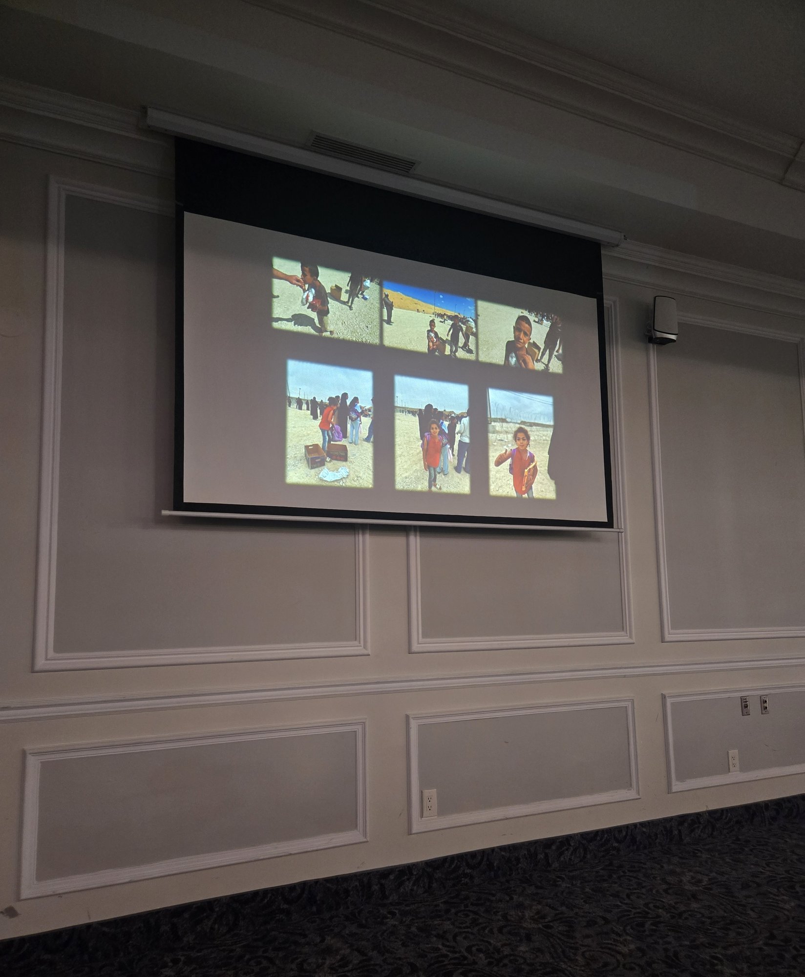 A projection screen showing six photos of children and crowds at a Gaza aid distribution site