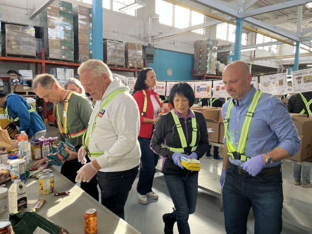 Doug Ford, Olivia Chow and Brad Bradford sorting food at Daily Bread Food Bank