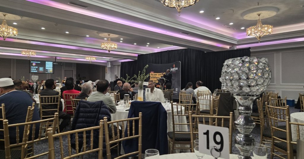 A full ballroom of seated guests facing the stage and screen at Justice For All Canada’s Love Ummah event in Toronto