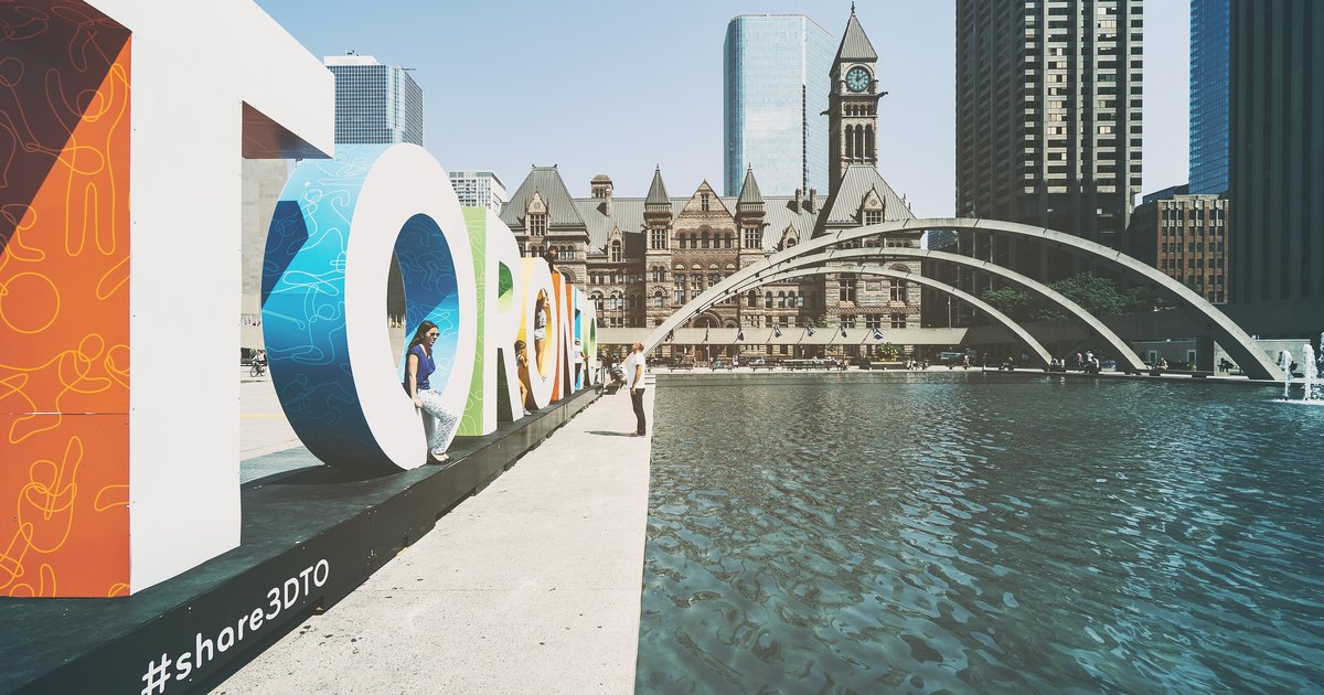 Nathan Phillips Square and the Toronto sign in front of Old City Hall on a sunny day