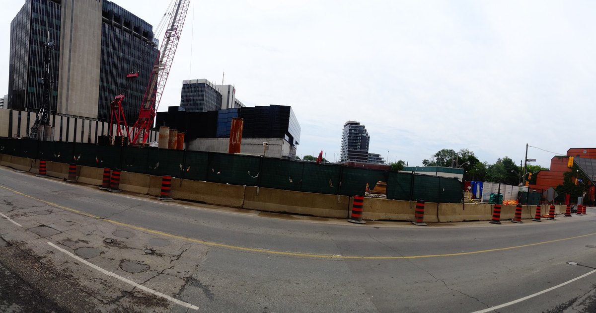 Construction site with a crane and barriers at Eglinton TTC Station in Toronto