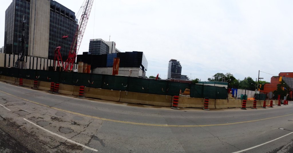Construction site with a crane and barriers at Eglinton TTC Station in Toronto