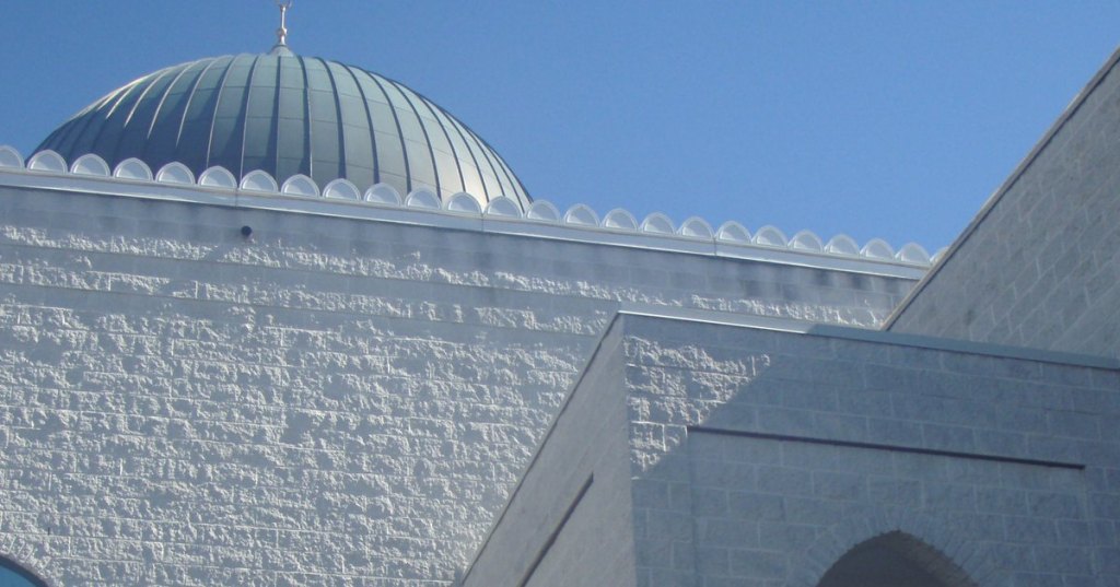 The dome of a mosque on Victoria Park Avenue in Toronto against a blue sky