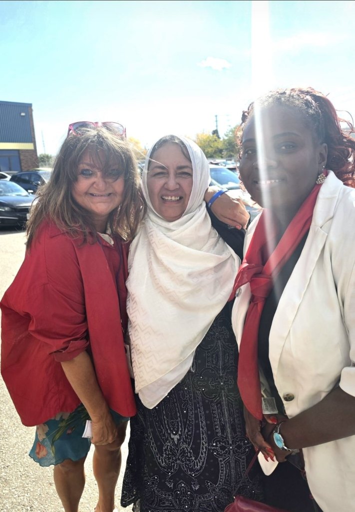 Bahira Abdulsalam outdoors with two smiling supporters in Toronto